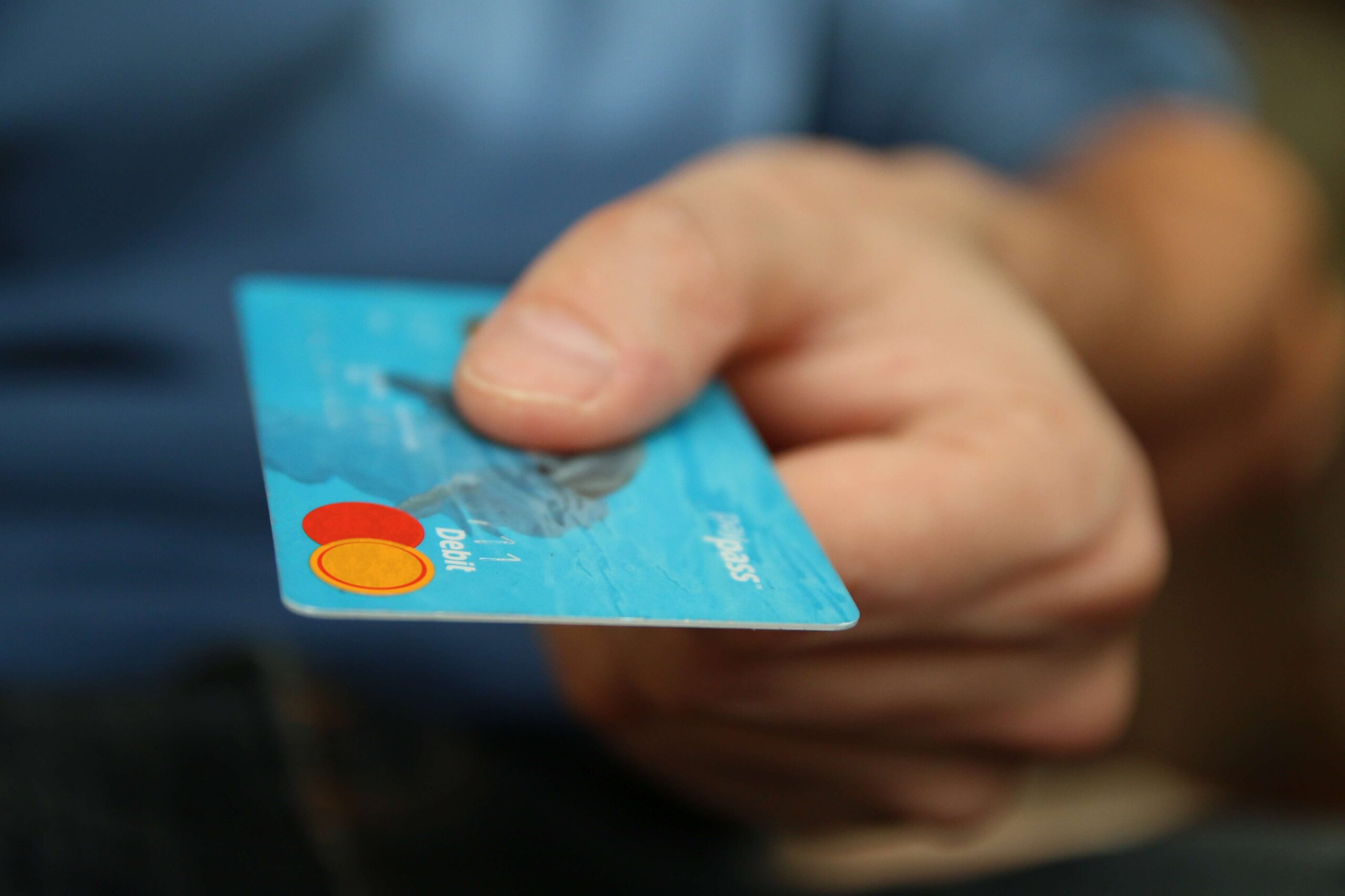 Image of hand holding a debit card